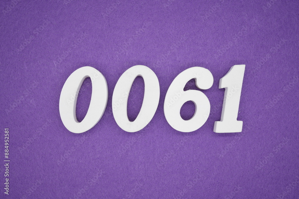 The numbers are made of white paint wood, placed on the background as a purple paper. The numbers are made of white paint wood, placed on the background as a purple paper.