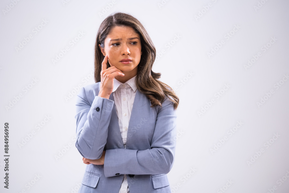 Portrait of pensive and exhausted businesswoman who is looking away and thinking. Portrait of pensive and exhausted businesswoman who is looking away and thinking.