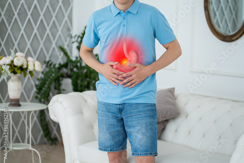 Stomach ulcer, man with abdominal pain suffering at home, symptoms of gastritis, diseases of the digestive system