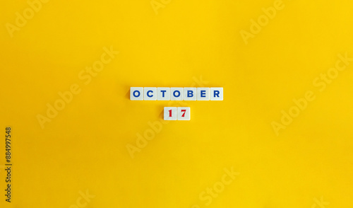 October 17. Text on Block Letter Tiles on Yellow Background. Minimal Aesthetics.