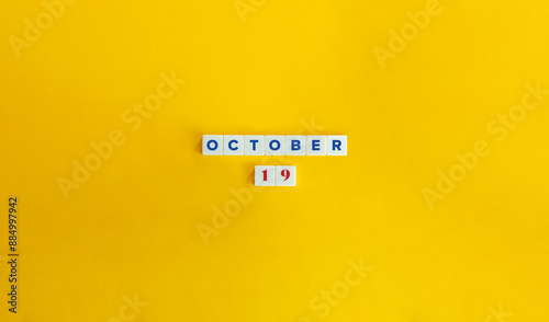 October 19. Text on Block Letter Tiles on Yellow Background. Minimal Aesthetics.