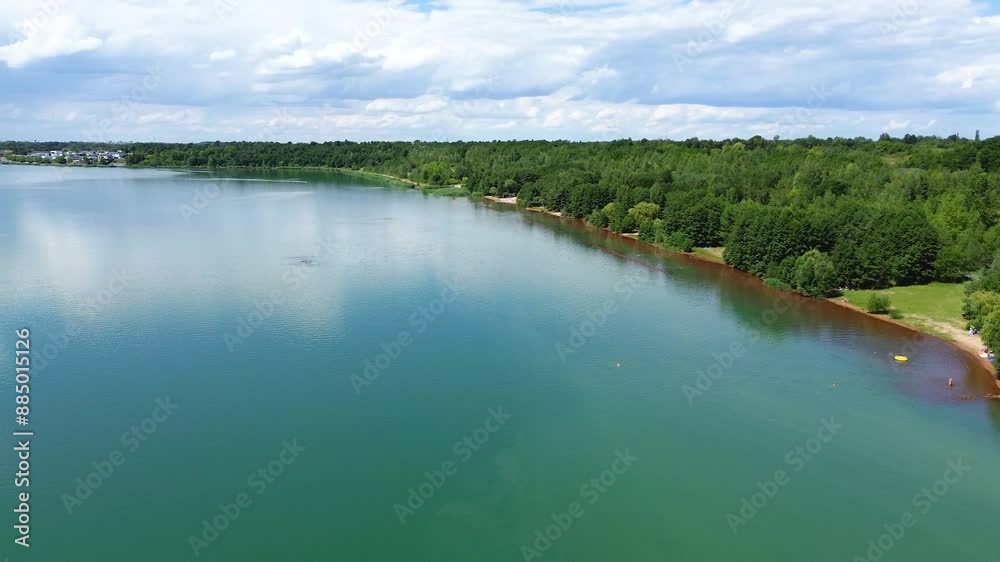 flyover beautiful lake with embankment, trees and blue sky reflections flyover beautiful lake with embankment, trees and blue sky reflections