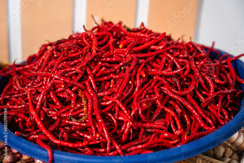 pile of Fresh Chilies and Ripe Red Chilies in Baskets for Sale at the Vegetable Market photo