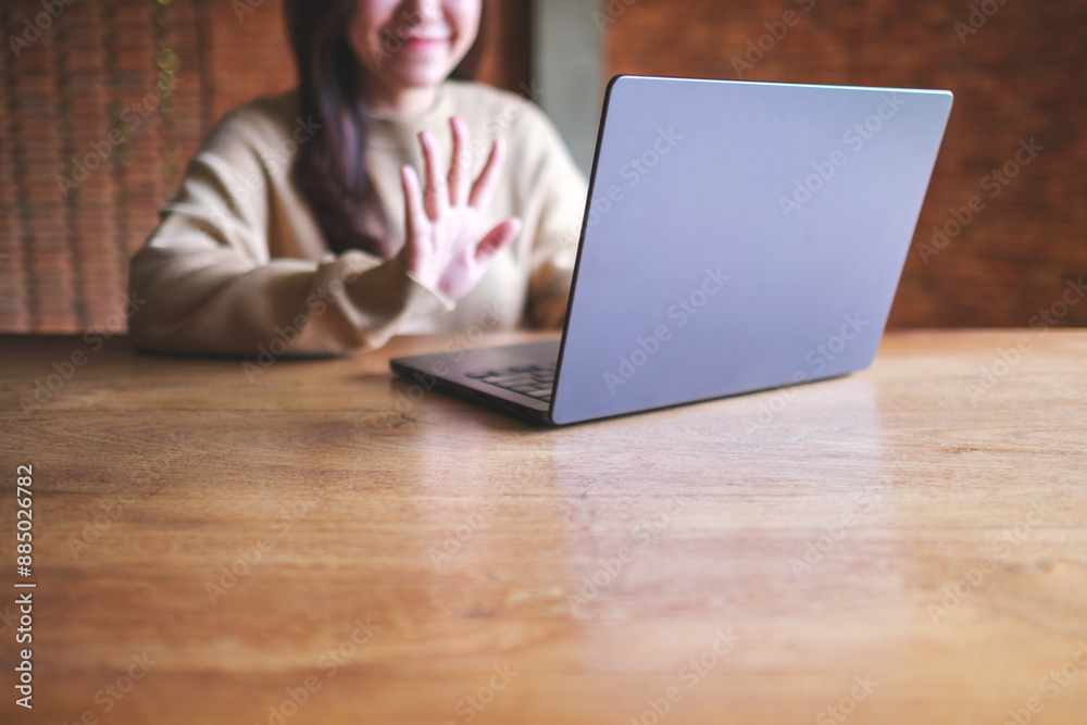 Closeup of a young woman using laptop computer for video call and working or studying online at home Closeup of a young woman using laptop computer for video call and working or studying online at home