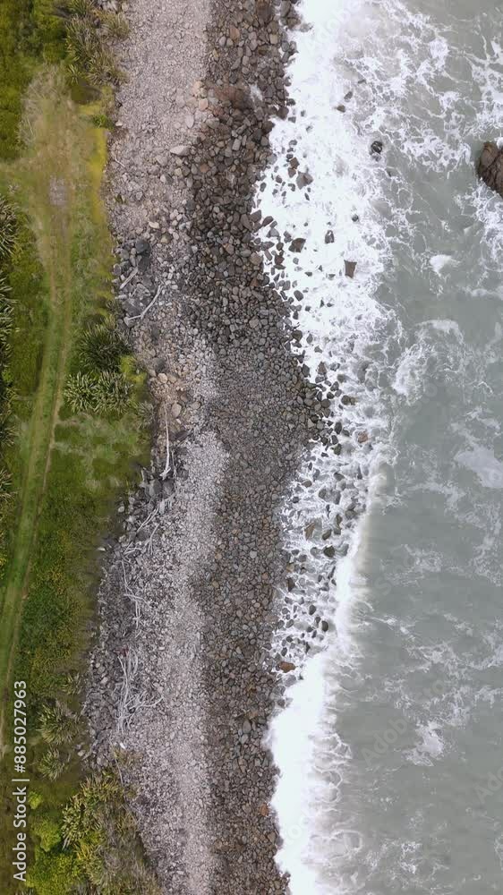 Waves crashing on the rocky beach in New Zealand Waves crashing on the rocky beach in New Zealand