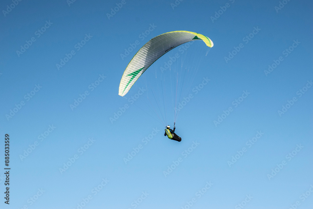 paraglider in the sky in the mountains in winter paraglider in the sky in the mountains in winter