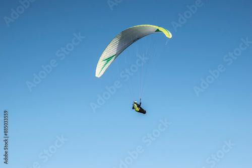 paraglider in the sky in the mountains in winter photo