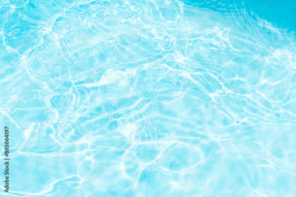 Blue water with ripples on the surface. Defocus blurred transparent blue colored clear calm water surface texture with splashes and bubbles. Water waves with shining pattern texture background. Blue water with ripples on the surface. Defocus blurred transparent blue colored clear calm water surface texture with splashes and bubbles. Water waves with shining pattern texture background.