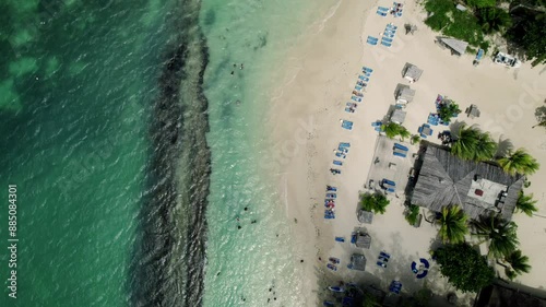 Slow panning up of tropical beach shot of blue sky turquoise water in st. ann's ochos rios Jamaica stunning view and scenery destination vacation photo