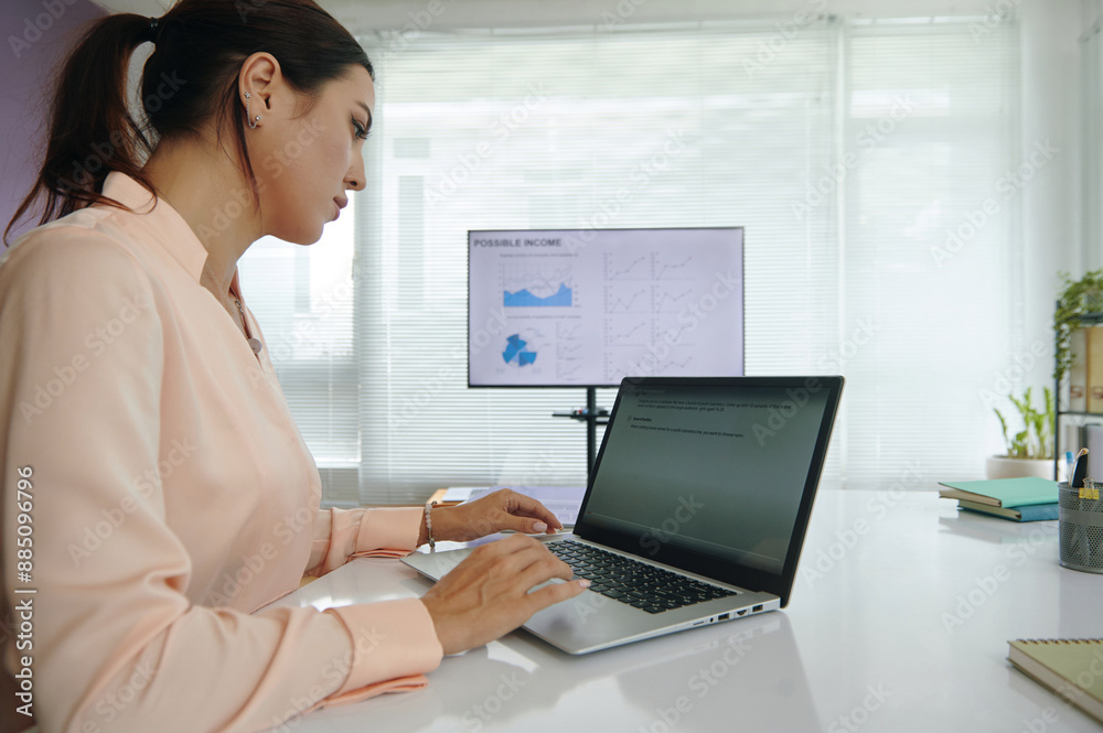 Marketing specialist working online with vlm model on laptop and developing project while sitting at her workplace in office Marketing specialist working online with vlm model on laptop and developing project while sitting at her workplace in office