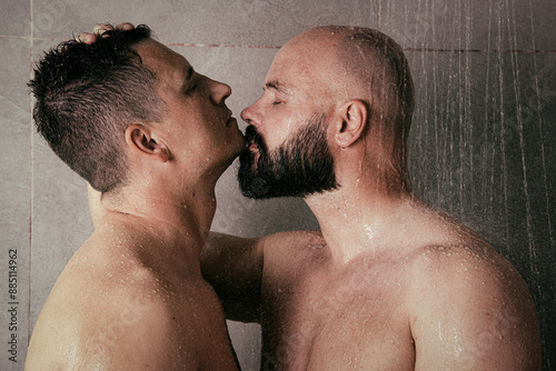 Early morning. An adult gay couple showers together and kisses. Love and romantic relationship between two men.