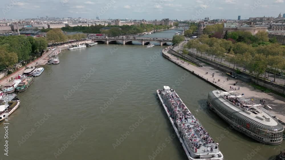 Boats navigating along Seine River with Paris cityscape in background, France. Aerial drone flyback
Boats navigating along Seine River with Paris cityscape in background, France. Aerial drone flyback