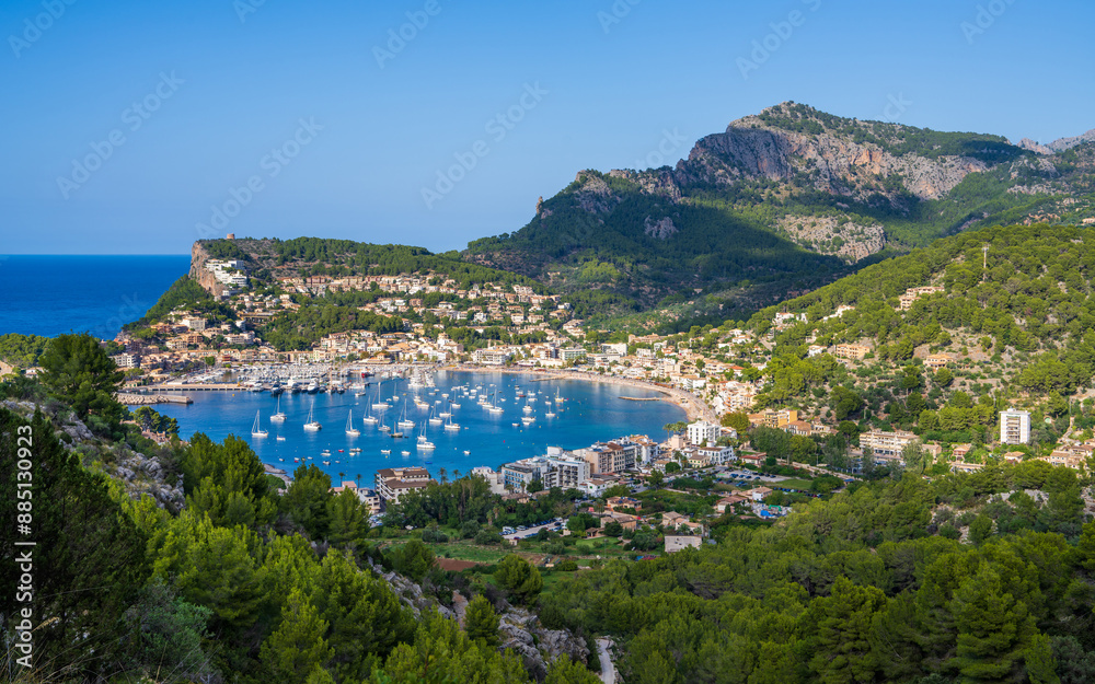 Obraz premium Beautiful view of the harbor with many yachts, ships in the Balearic village of Puerto de Soller, a popular holiday destination in Mallorca. Sunny day, vacation time.