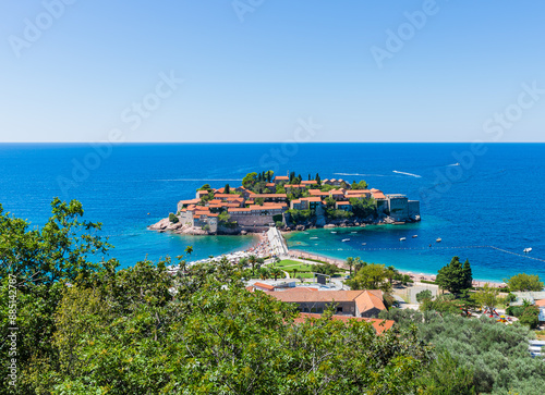 View of the island of Sveti Stefan from the mountain on a sunny day photo