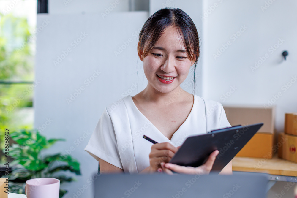 Portrait business woman smile and use tablet checking information on parcel shipping box before send to customer. Entrepreneur small business working at home. SME business online marketing.
Portrait business woman smile and use tablet checking information on parcel shipping box before send to customer. Entrepreneur small business working at home. SME business online marketing.