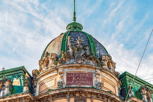 Lviv, Ukraine - November 2, 2023: Three-figure sculptural group Thrift by Leonard Marconi in the attic of the Galician Savings Bank building in Lviv, 1891. Ancient statue on the building dome close-up photo