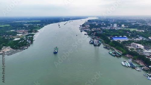 Peaceful River Journey with Boats Navigating Calm Waters and Verdant Shores photo