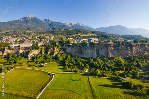 Summer aerial morning view of Embrun and its famous cliff-top plateau known as Le Roc. Durance Valley in Hautes-Alpes. French Alps, France photo