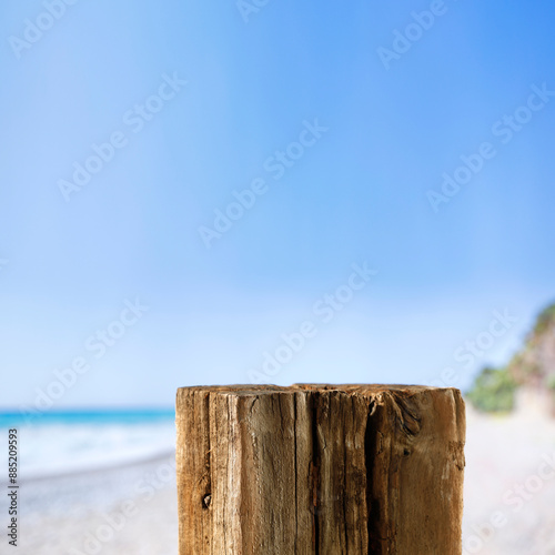 Fototapeta Naklejka Na Ścianę i Meble -  Old wooden stump as table background with beach and seascape view. Copy space for products and objects display montage. 