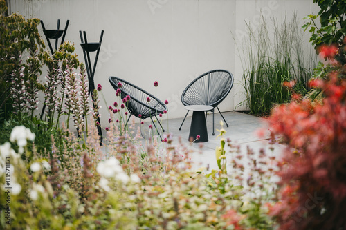 Fototapeta Naklejka Na Ścianę i Meble -  Garden lounge set in a beautiful colourful garden