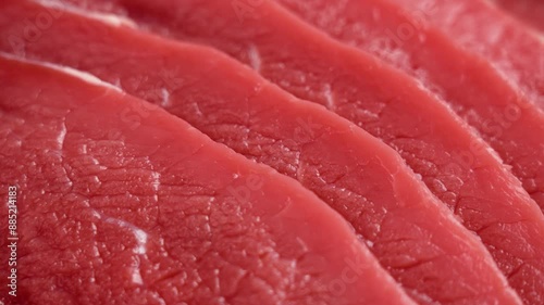 Raw beef escalope. Thinly sliced ​​fresh red meat steak. Close up. Rotation