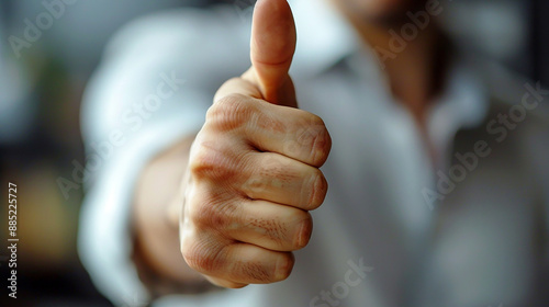 Wide horizontal background banner image of a handsome young person's hand showing thumbs up with blank copy space photo