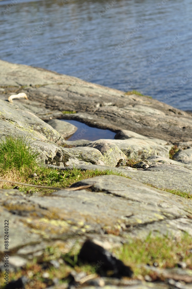 Transparent blue water by the seashore. Puddle of water and cracks with grass vectors at a cliff. Beautiful calm scenary in paradise. Transparent blue water by the seashore. Puddle of water and cracks with grass vectors at a cliff. Beautiful calm scenary in paradise.
