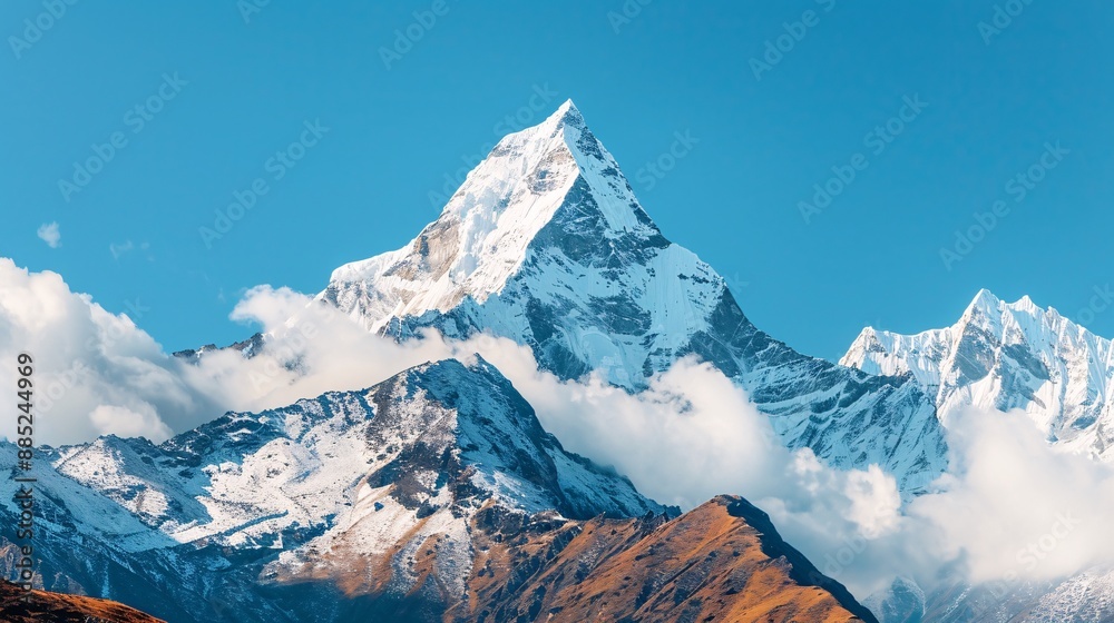 Majestic Snow-Capped Mountain Peak Against a Blue Sky. Majestic Snow-Capped Mountain Peak Against a Blue Sky.
