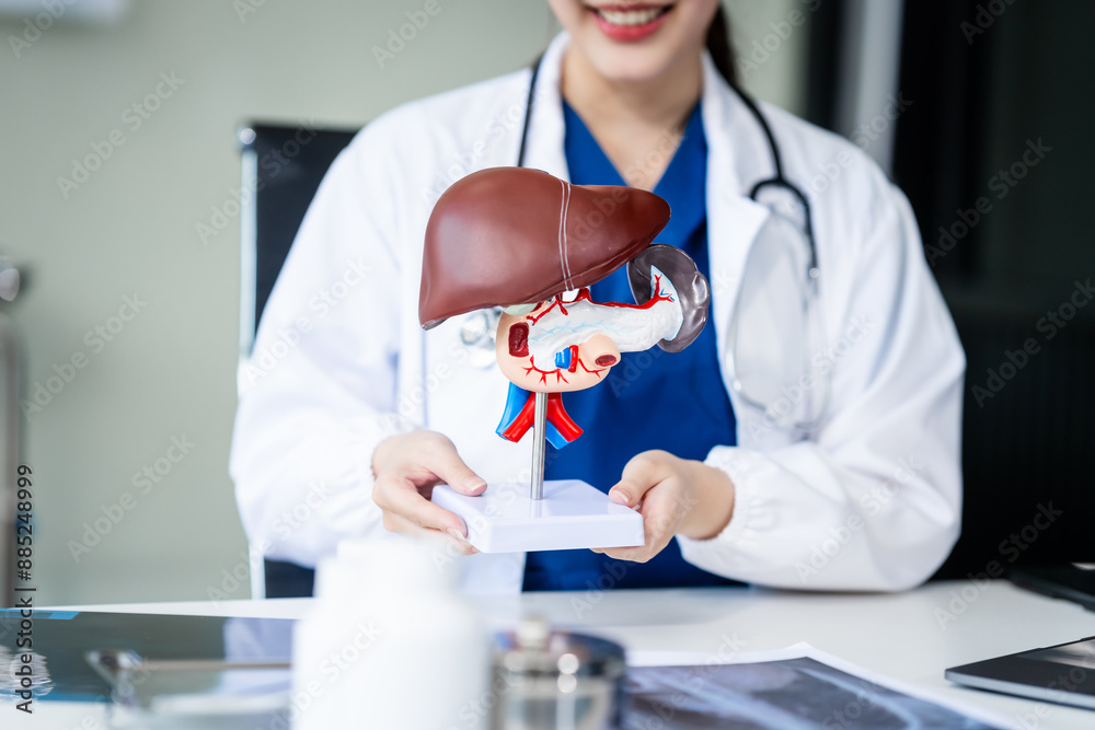 A young female nurse works at a desk, discussing liver-related conditions with a grey-haired Asian mature woman, including liver disease, hepatitis, cirrhosis, and liver cancer. A young female nurse works at a desk, discussing liver-related conditions with a grey-haired Asian mature woman, including liver disease, hepatitis, cirrhosis, and liver cancer.