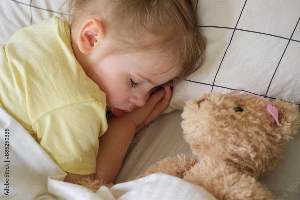 Peaceful adorable baby sleeping on a bed at home. Slumbering little child. Two years old girl sleeps peaceful at domestic room interior background. Serene dream. Cute face close up. Deep kid slumber Peaceful adorable baby sleeping on a bed at home. Slumbering little child. Two years old girl sleeps peaceful at domestic room interior background. Serene dream. Cute face close up. Deep kid slumber