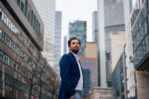 Wallpaper Mural Confident businessman standing in front of buildings Torontodigital.ca