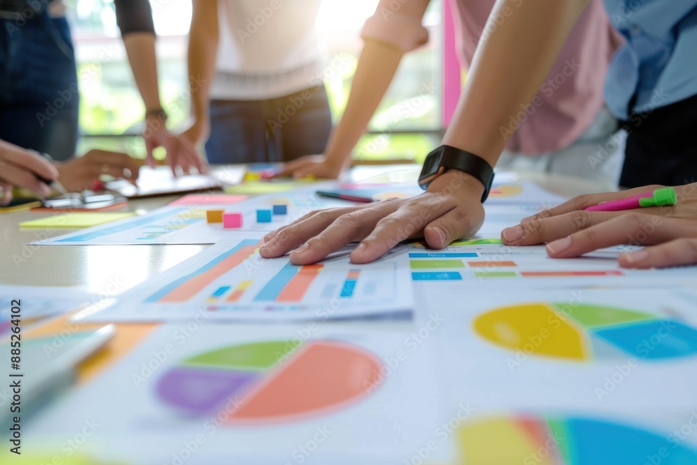 Group of people collaborating on charts and graphs, analyzing data and discussing strategies during a business meeting, emphasizing teamwork and productivity. Group of people collaborating on charts and graphs, analyzing data and discussing strategies during a business meeting, emphasizing teamwork and productivity.