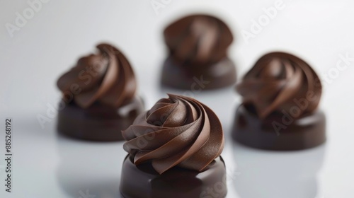 Elegant chocolate pralines with glossy swirl topping