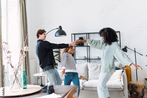 Happy family havin fun dancing together in the living room photo