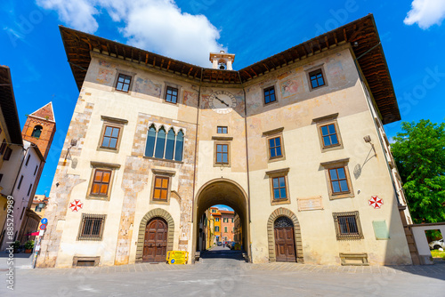 Pisa, Italy - June 02, 2024: Pisa view of Palazzo dell'Orologio (clock's palace) or Torre della Fame (Hunger Tower). Sunny day, clear sky.