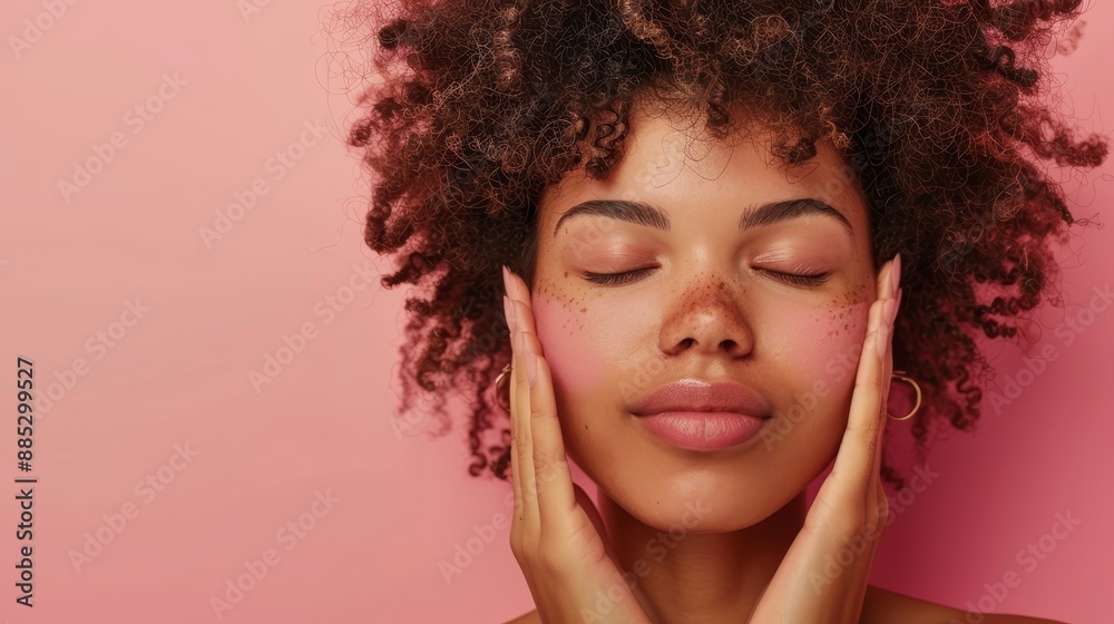 An attractive natural girl smiling, rubbing her face with facial cleanser for glowing, healthy skin. A curly young woman showering, using skincare products for hydration, with pink background. An attractive natural girl smiling, rubbing her face with facial cleanser for glowing, healthy skin. A curly young woman showering, using skincare products for hydration, with pink background.
