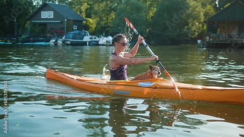 Wallpaper Mural A woman with her small dog is rowing a kayak on the river Torontodigital.ca