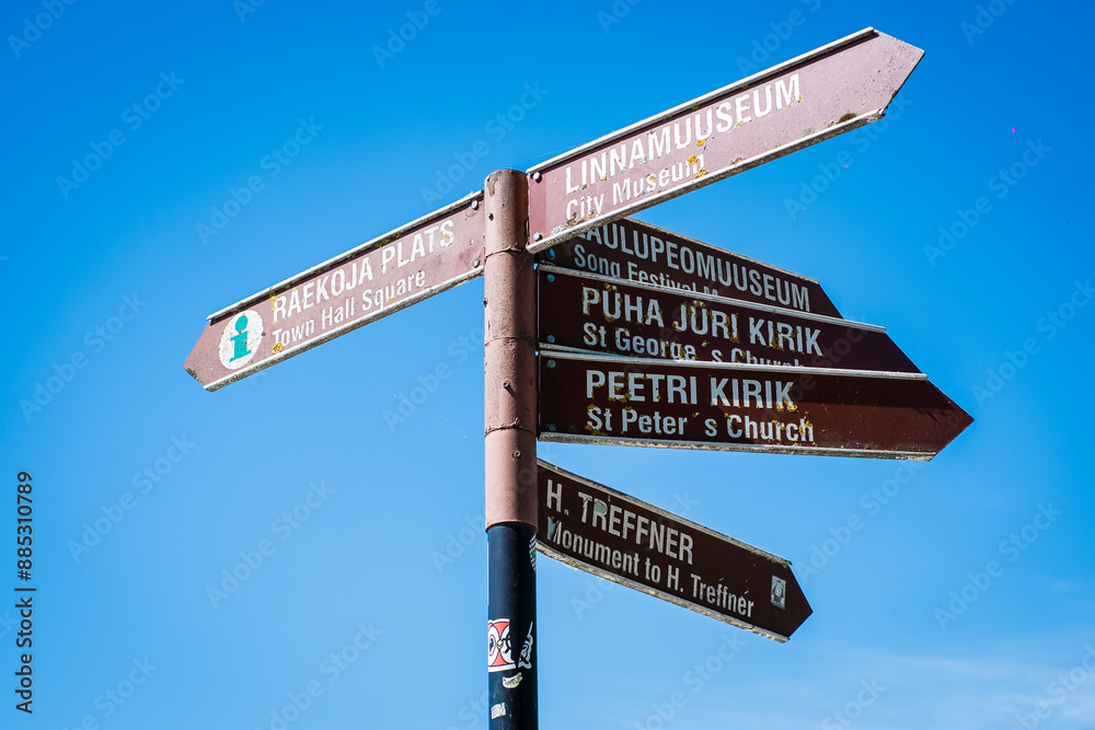 Fototapeta premium Tartu, Estonia - May 25, 2024: Sign pointing to different sights and tourist attractions in Tartu, Estonia. Travel information signpost for Tartu visitors.