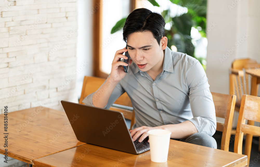 Young business man working at a coffee shop Young business man working at a coffee shop