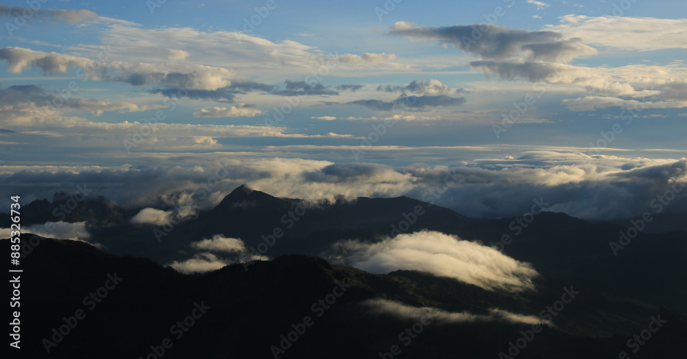 Bright lit clouds over hills in the Entlebuch Region, Switzerland. Bright lit clouds over hills in the Entlebuch Region, Switzerland.