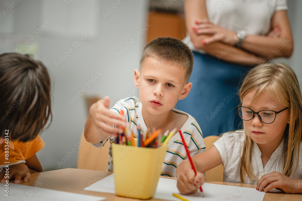 Young students paint and draw on class in the classroom Young students paint and draw on class in the classroom