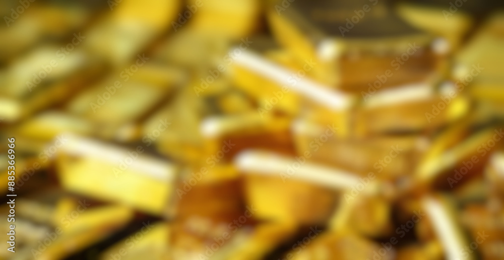 Blurred close-up of shiny golden ingots stacked as wealth symbol, luxury investment for financial success. Blurred close-up of shiny golden ingots stacked as wealth symbol, luxury investment for financial success.