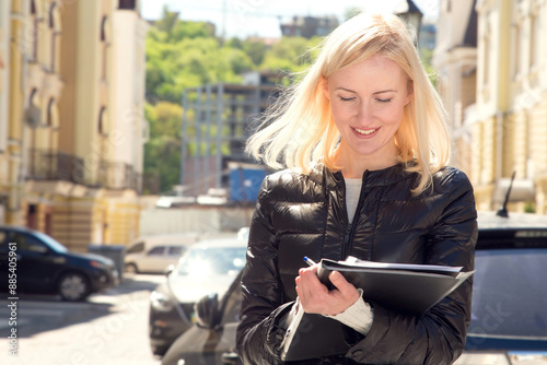 Female insurance agent or sales agent draws up contract documents. Business woman with a folder of documents in her hand, real estate agent. Woman conducts a survey and records data.