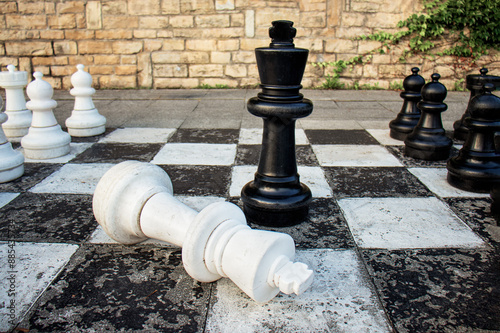 game of chess, the concept of Black winning over White,
black chess piece king victory over white king, business concept of victory over competitor photo