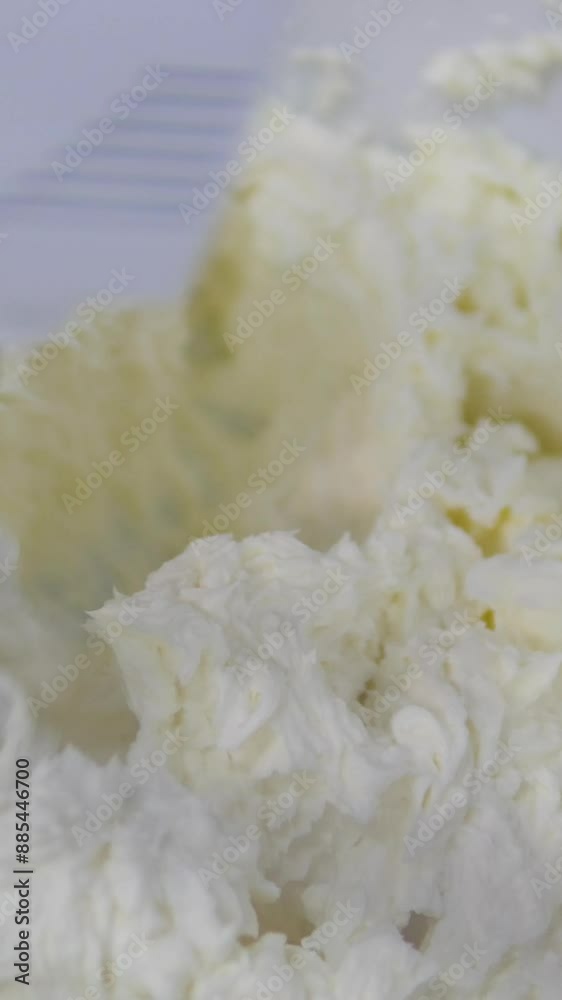 White butter cream in a metal bowl. Beating cream cake. Mixer whisk in cream. Beat cream cheese White butter cream in a metal bowl. Beating cream cake. Mixer whisk in cream. Beat cream cheese