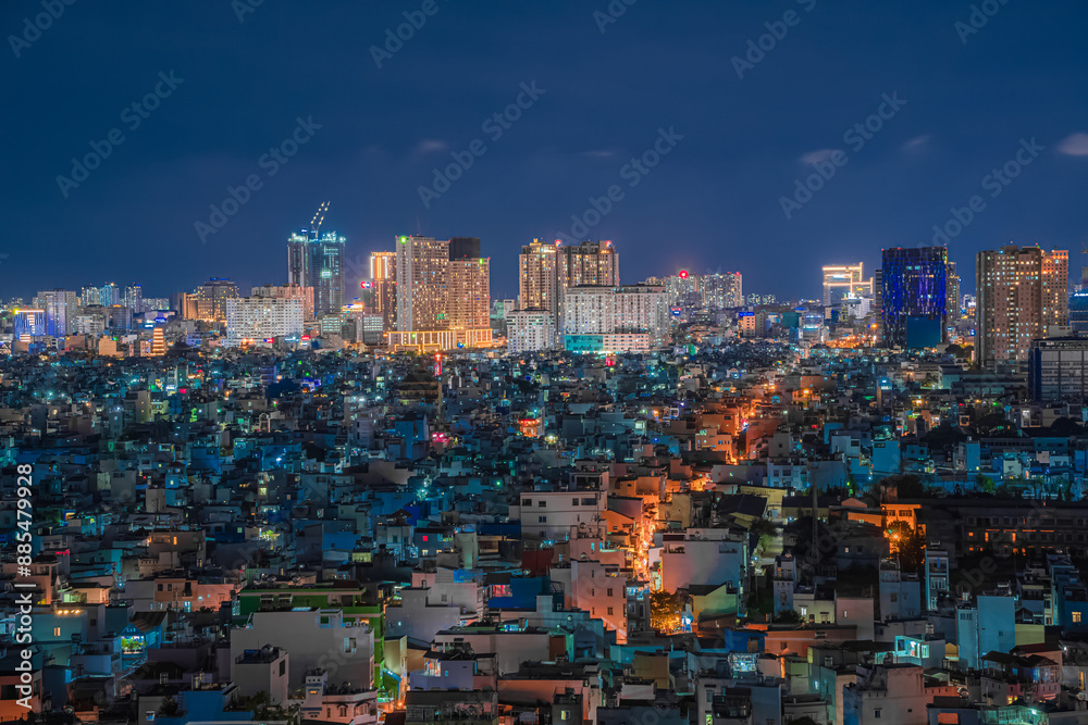 Awesome Ho Chi Minh City skyline. Night view of skyscrapers and other high-rise buildings at downtown of Ho Chi Minh City, Vietnam. Colorful city lights reflected in water of the Saigon River. Awesome Ho Chi Minh City skyline. Night view of skyscrapers and other high-rise buildings at downtown of Ho Chi Minh City, Vietnam. Colorful city lights reflected in water of the Saigon River.