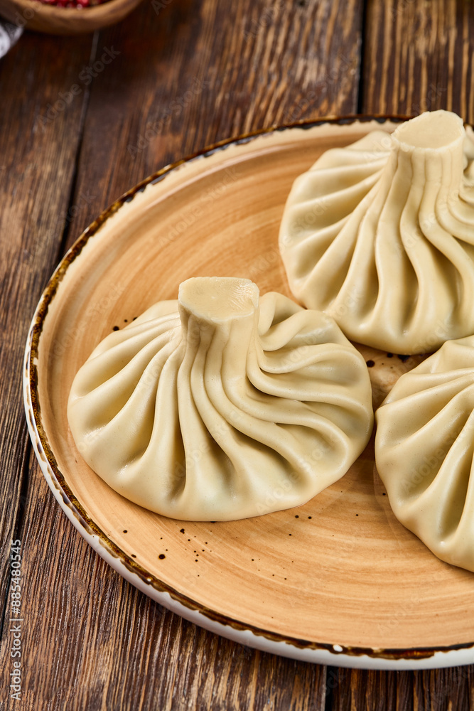 Delicious Traditional Georgian Khinkali Dumplings on a Wooden Plate Delicious Traditional Georgian Khinkali Dumplings on a Wooden Plate