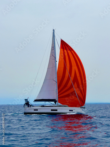 a sailboat with a red sail