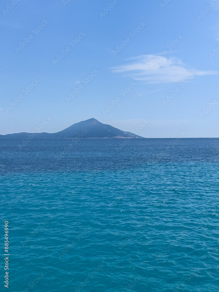 blue sea with a mountain in the background blue sea with a mountain in the background