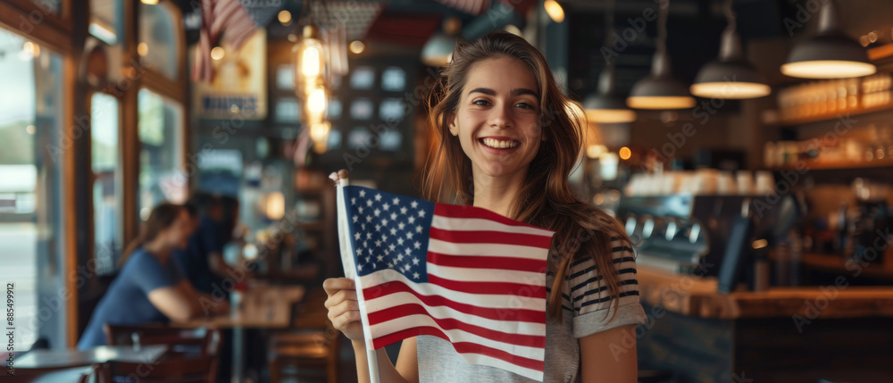 Joyful young woman holding an American flag inside a cozy cafe, radiating patriotism and a sense of community with a beaming smile. Joyful young woman holding an American flag inside a cozy cafe, radiating patriotism and a sense of community with a beaming smile.